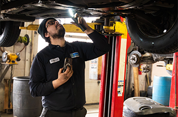 Technician inspecting a car